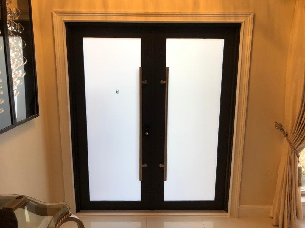 Motorized hurricane shutters installed on a home in Hialeah Florida with remote control operation providing complete storm protection