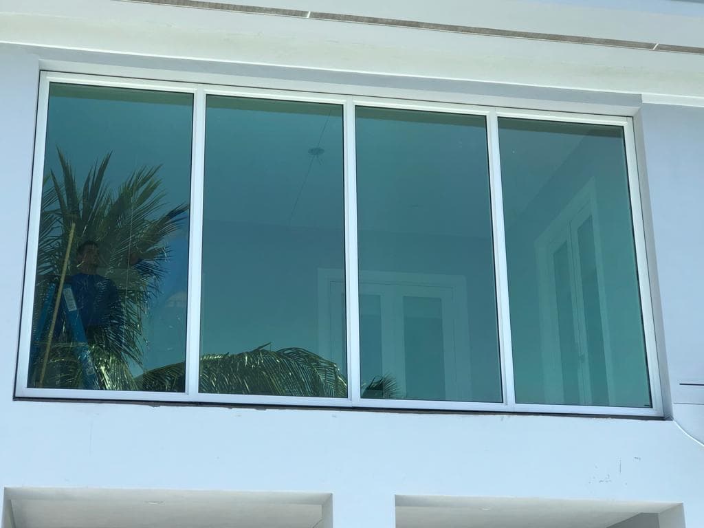 Frameless hurricane impact glass balustrade installed on a luxury property in South Beach Miami with ocean view through laminated safety glass