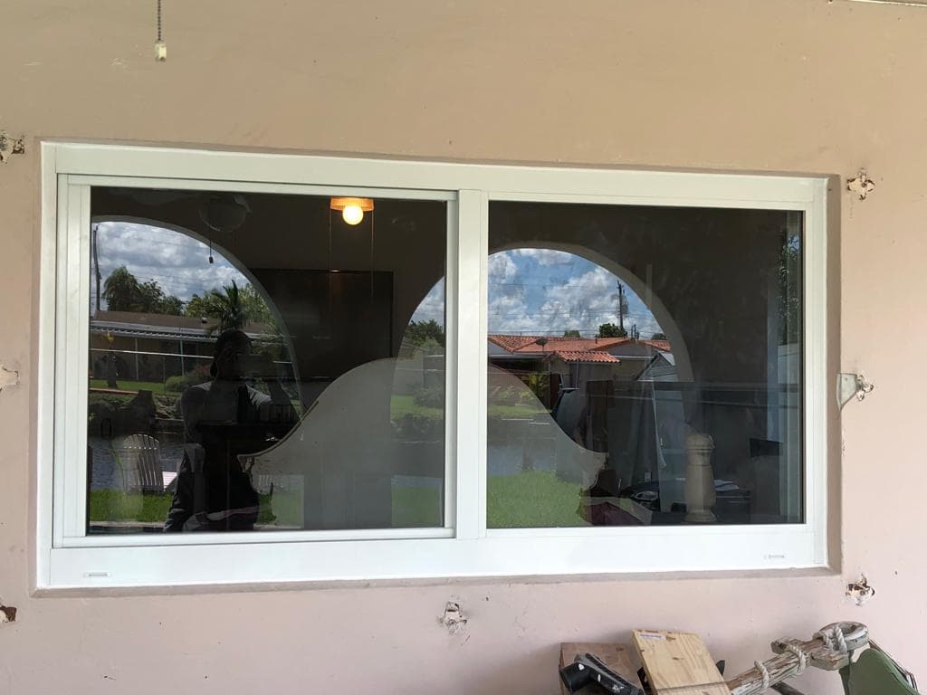 Impact windows replaced above kitchen countertops in a Florida home with bright natural light and hurricane protection above sink area