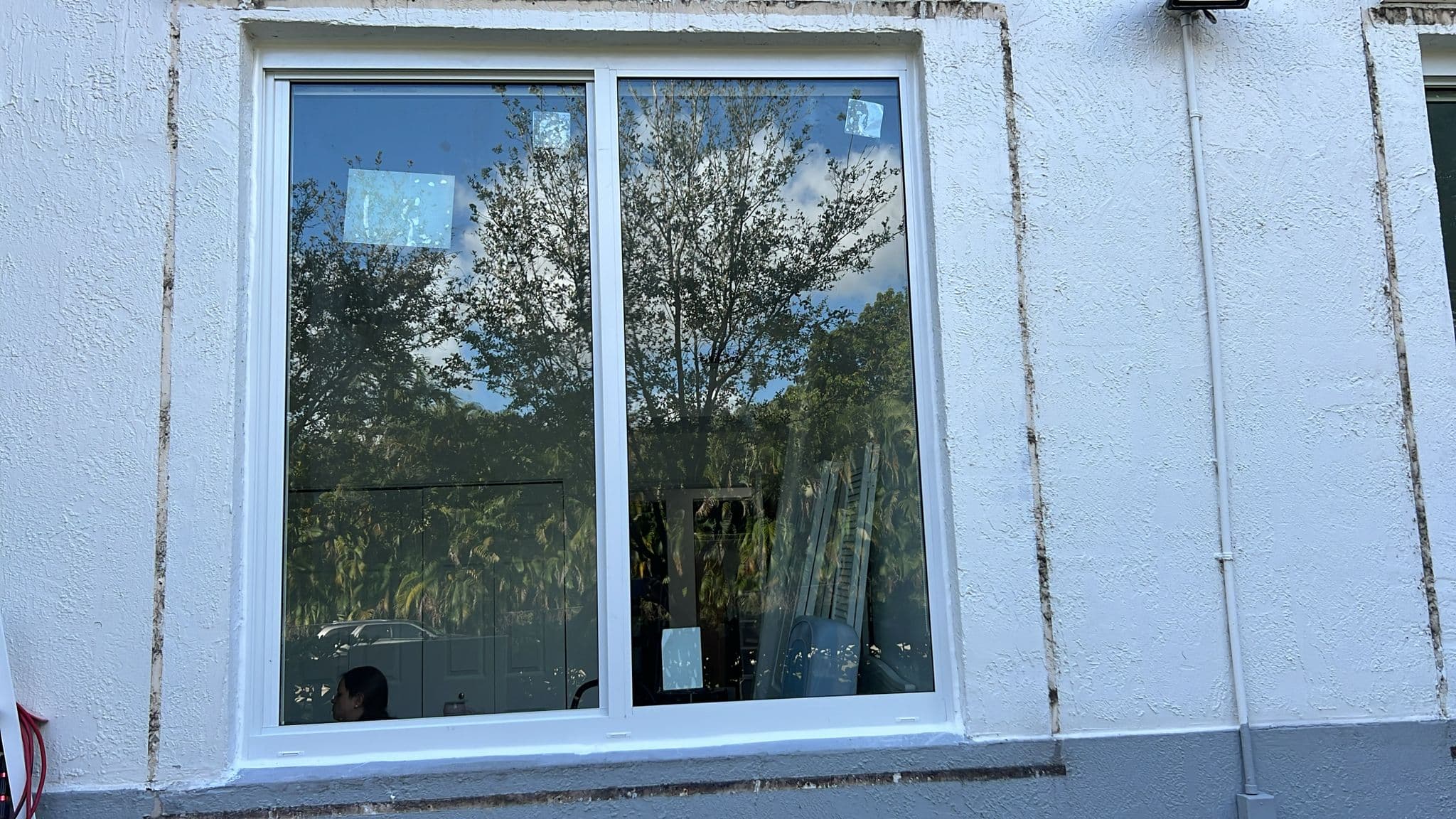 Detail photo of completed impact window installation showing frame glass and hardware quality on a Florida home project
