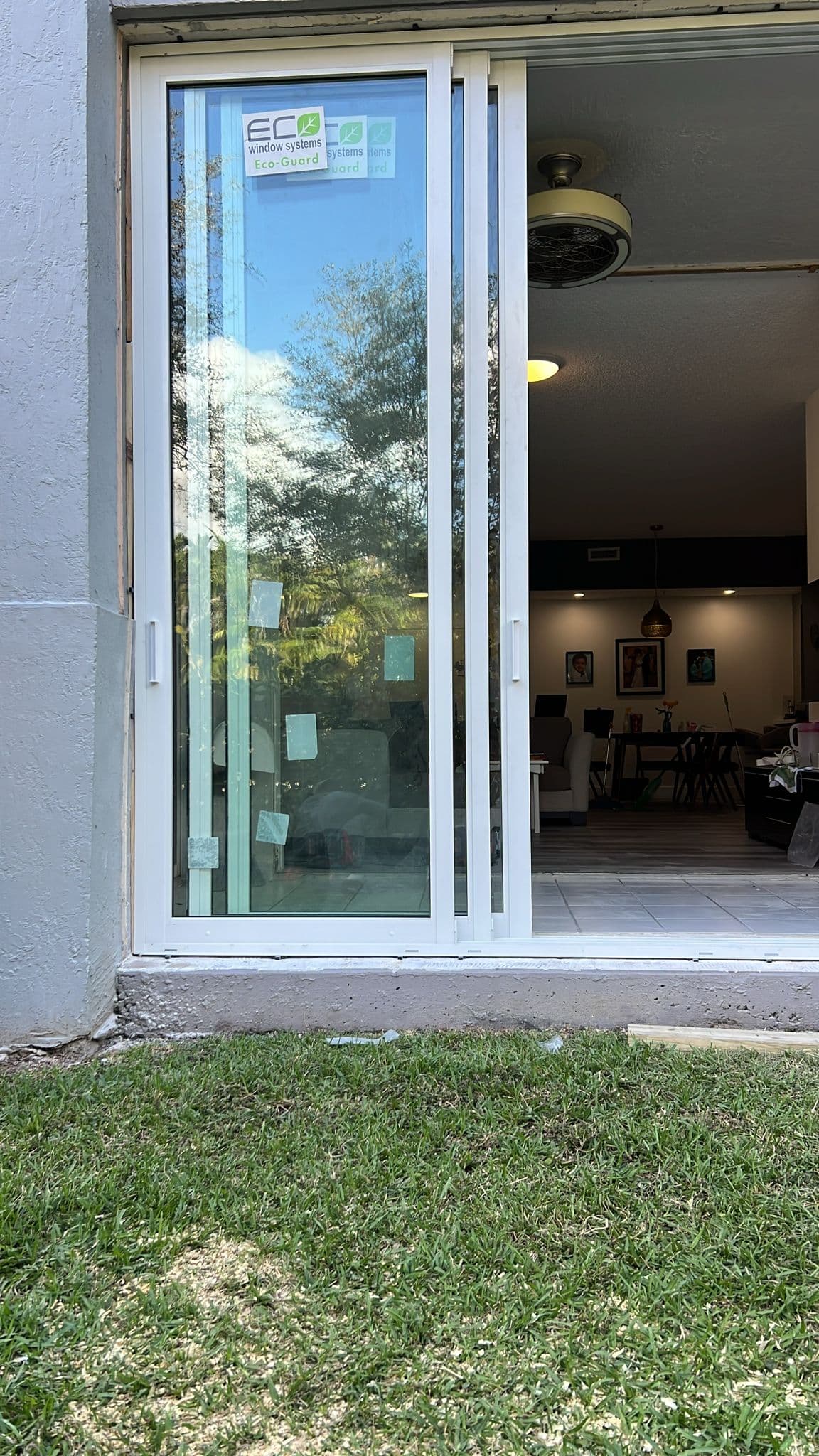 Interior view looking through newly installed impact windows on a Florida home showing clear glass and bright natural light