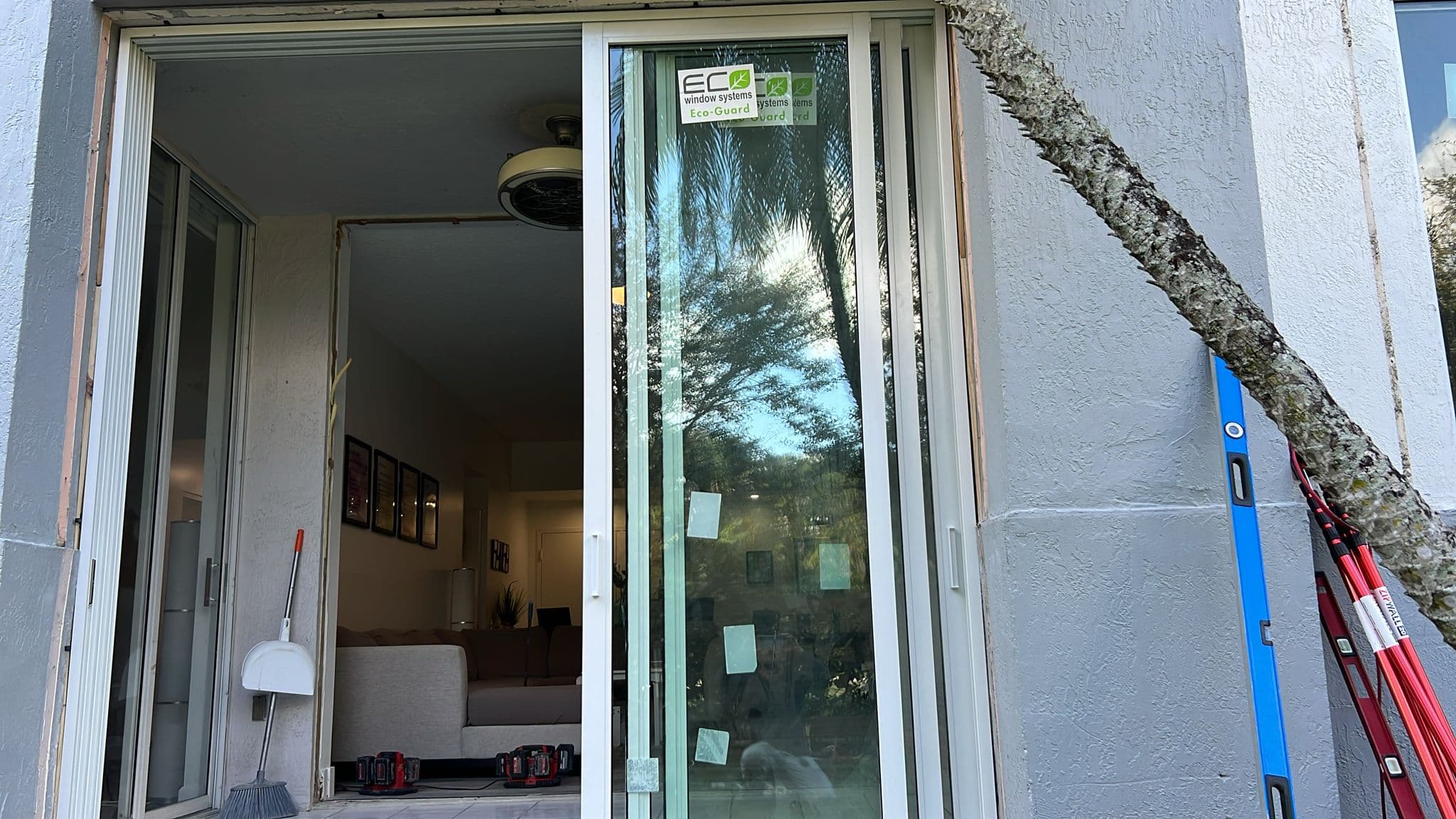 Exterior photo of completed impact window installation showing clean caulking professional trim and paint touch-up on a Florida home