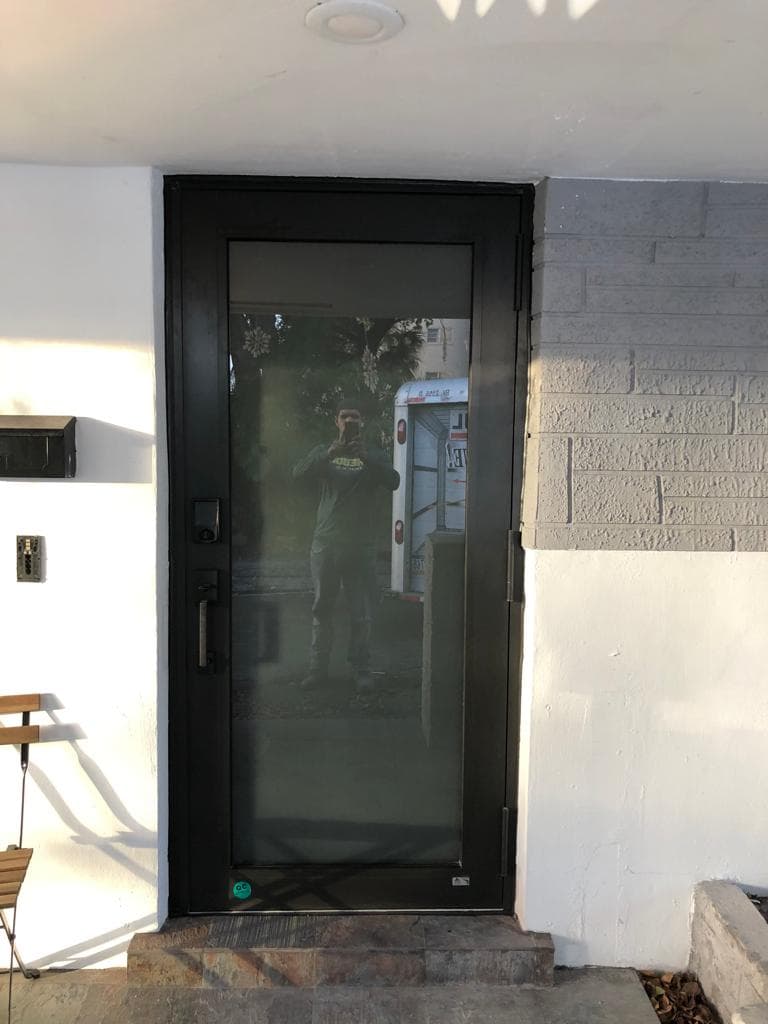 Close-up detail photo of impact window installation at a Florida property showing sealant application and frame attachment