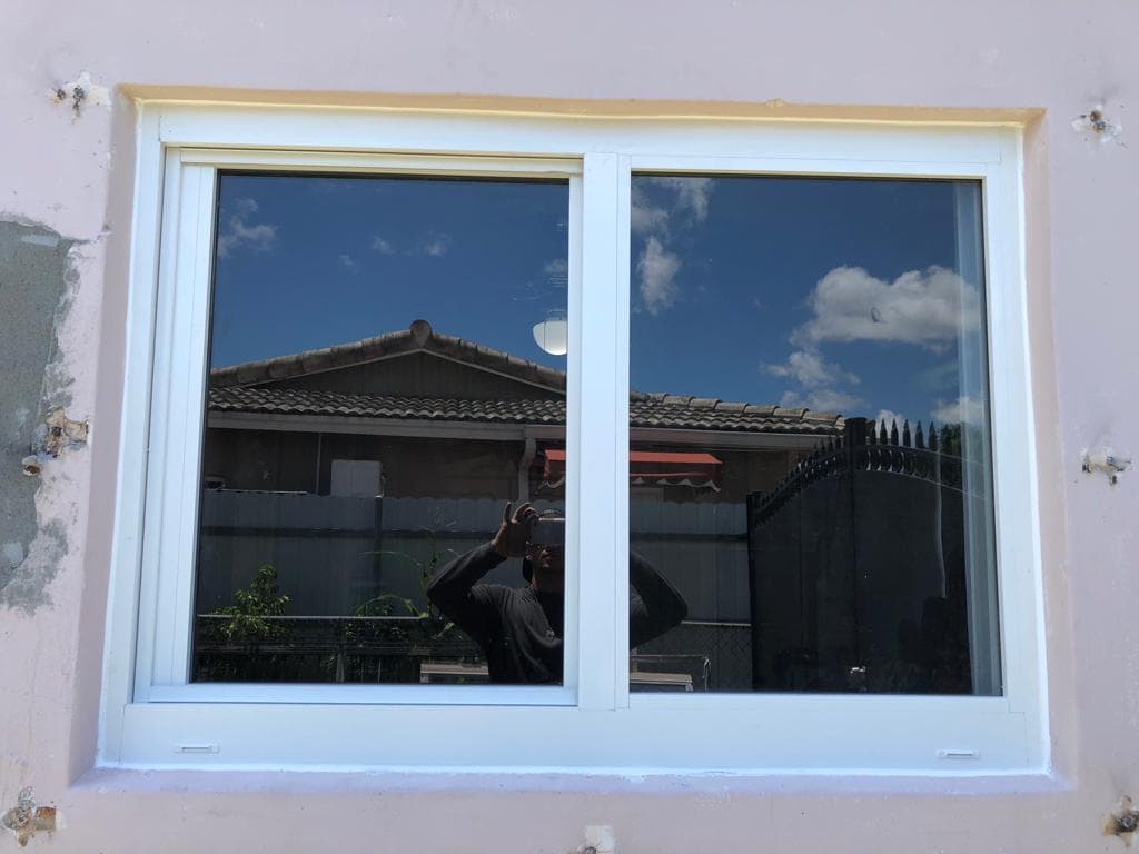 Completed impact window installation project on a Florida home showing multiple new windows with clean professional finish